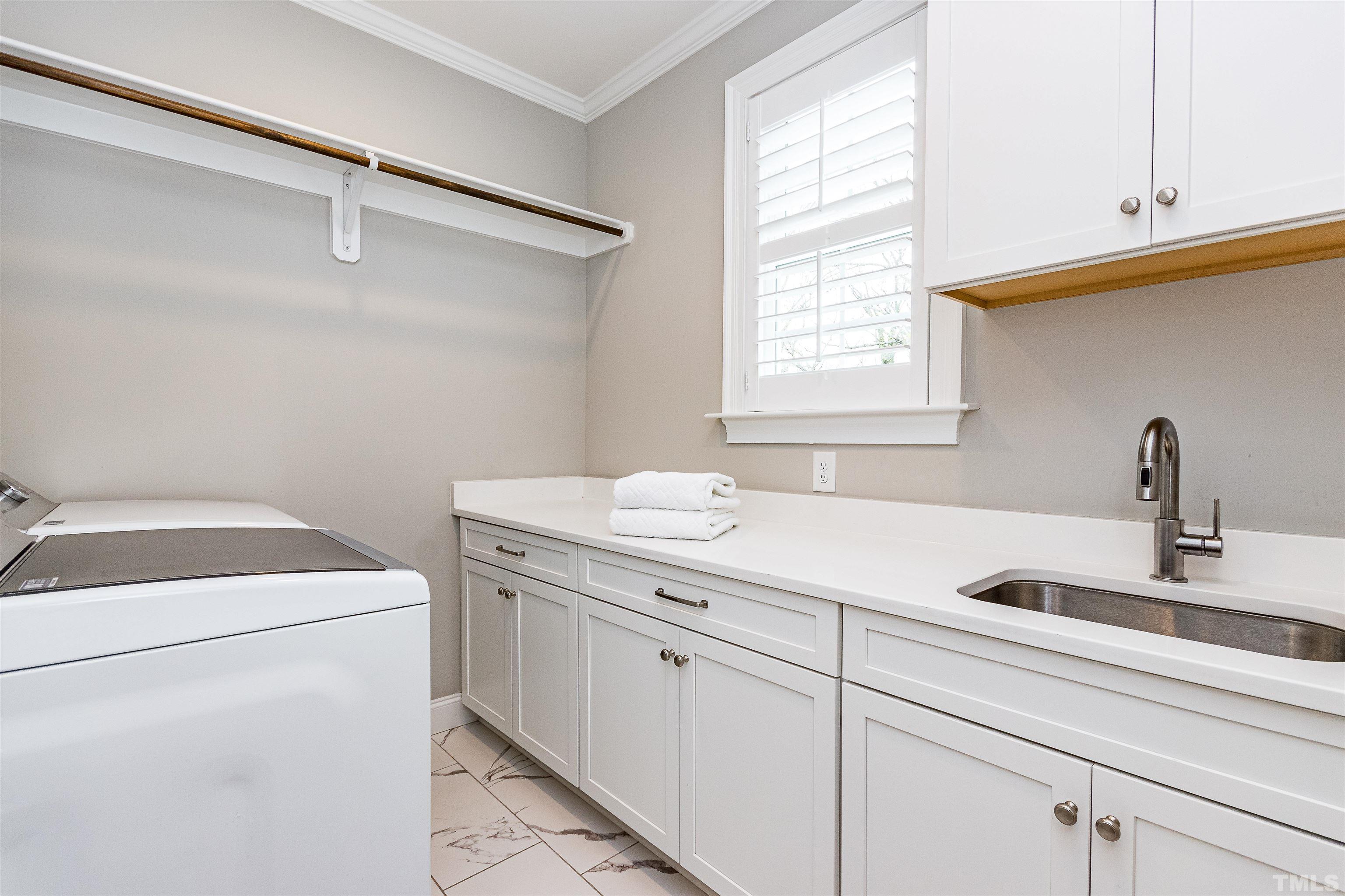 641 Cranbrook Road Raleigh, NC 27609 - Photo 30 of 39 a view of a storage and utility room with washer and dryer
