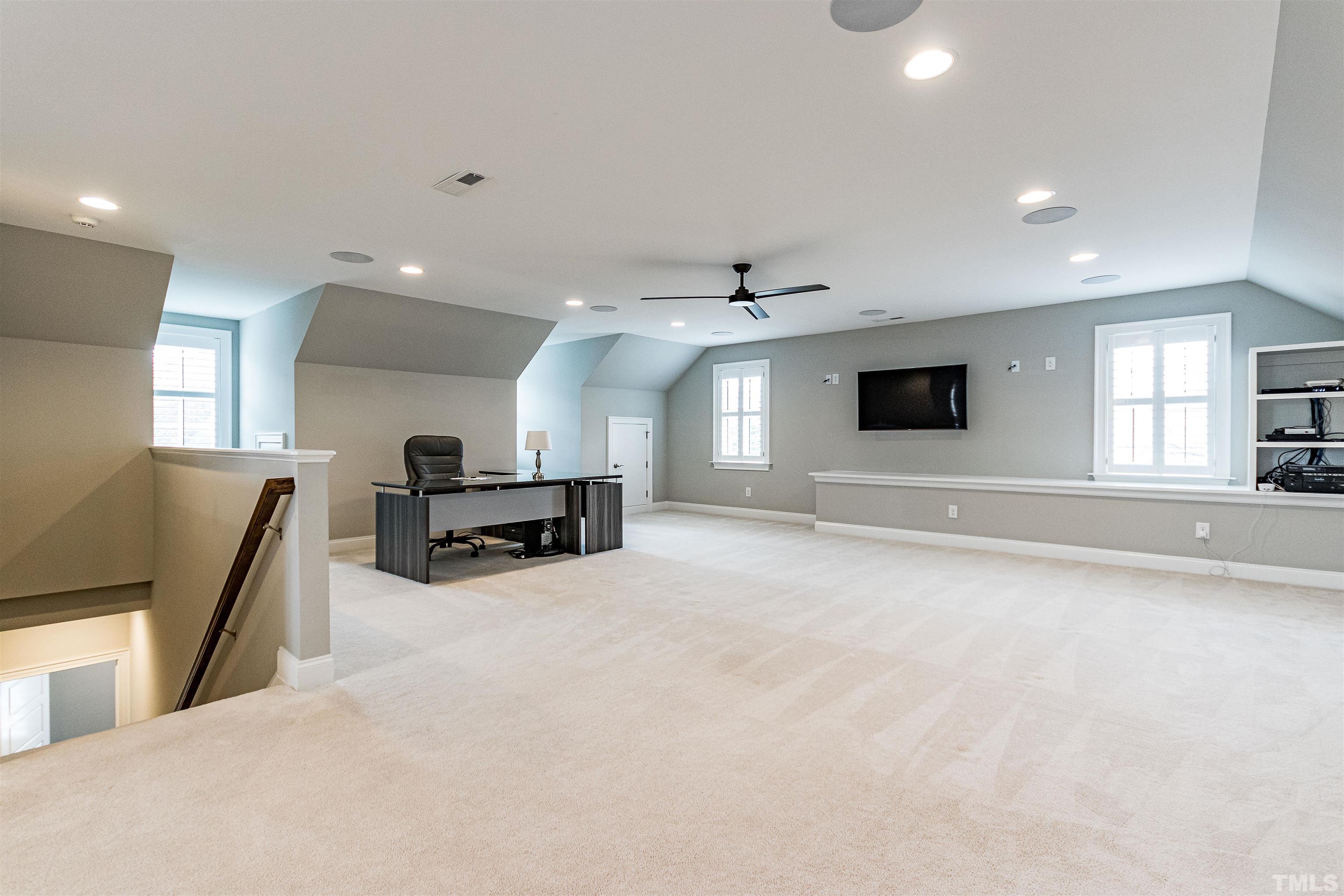641 Cranbrook Road Raleigh, NC 27609 - Photo 32 of 39 a living room with furniture and a flat screen tv