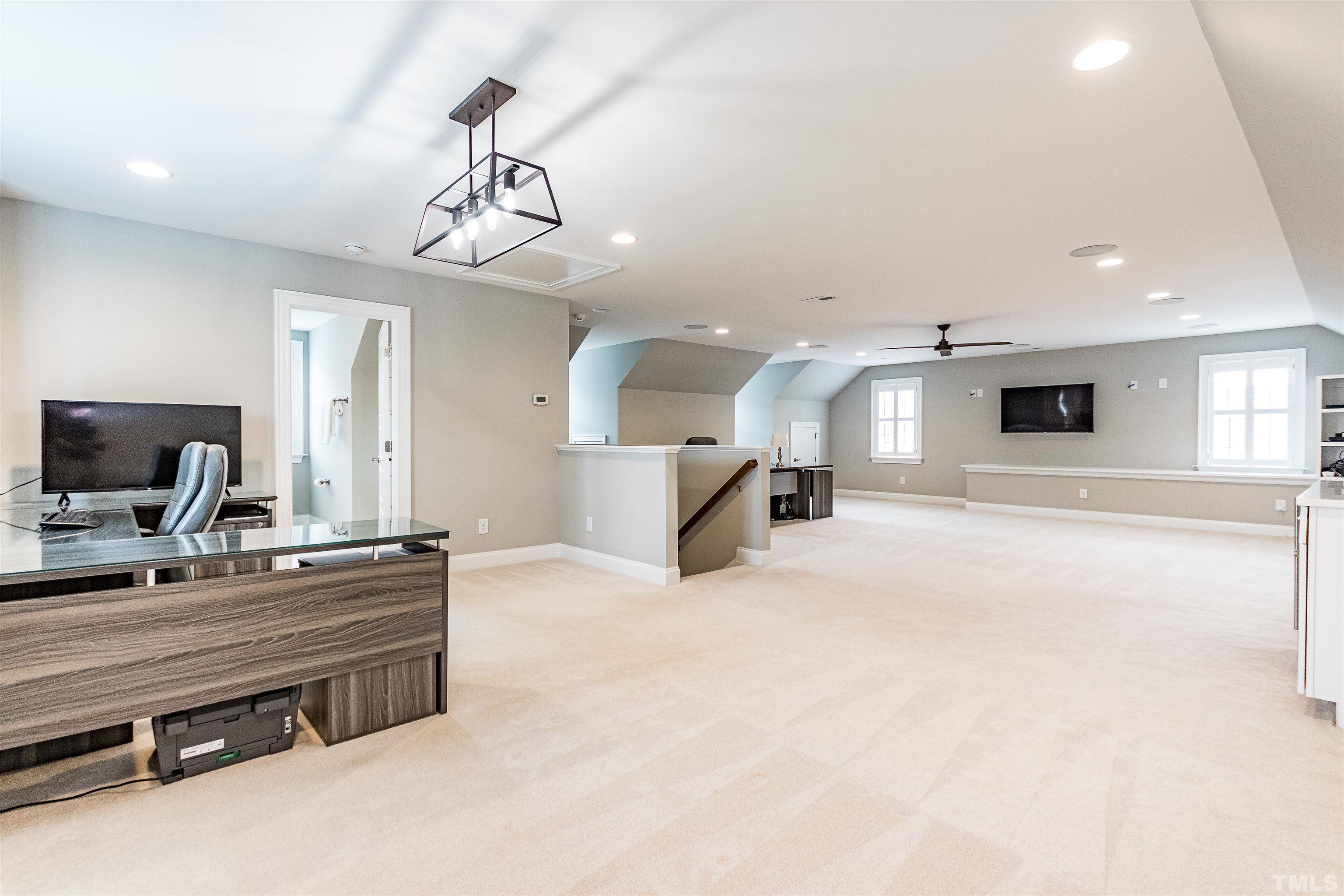 641 Cranbrook Road Raleigh, NC 27609 - Photo 33 of 39 a very nice looking room with a large mirror and a flat screen tv