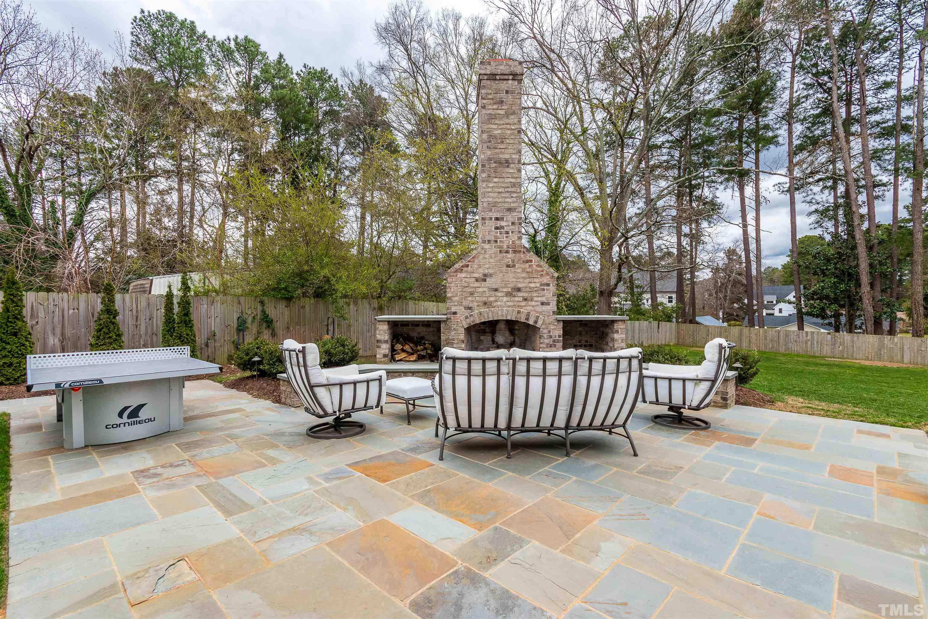 641 Cranbrook Road Raleigh, NC 27609 - Photo 37 of 39 a view of a patio with a table and chairs
