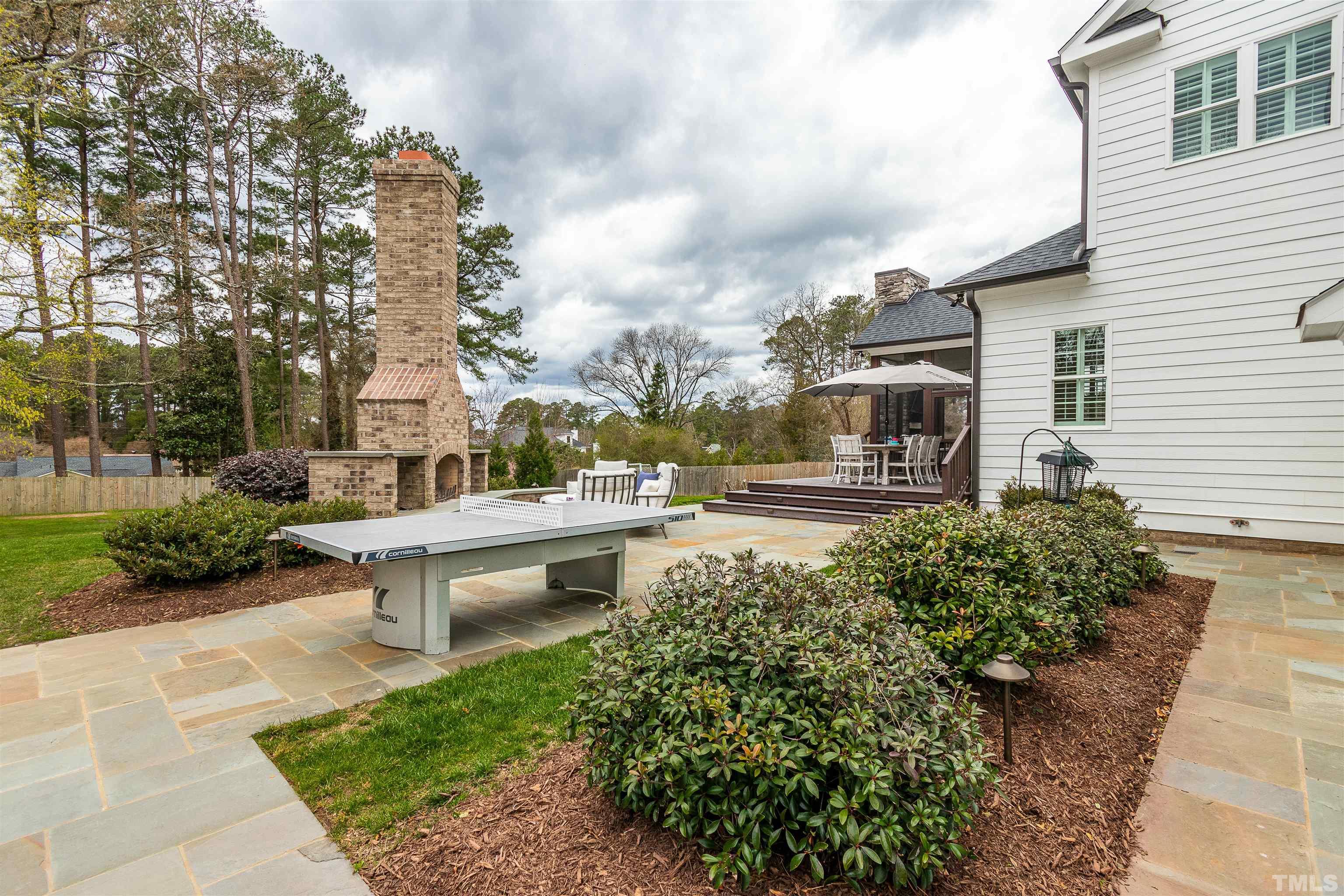 641 Cranbrook Road Raleigh, NC 27609 - Photo 38 of 39 a view of a patio with table and chairs and potted plants