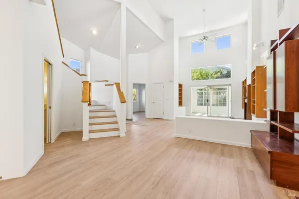 an empty room with a window and wooden floor