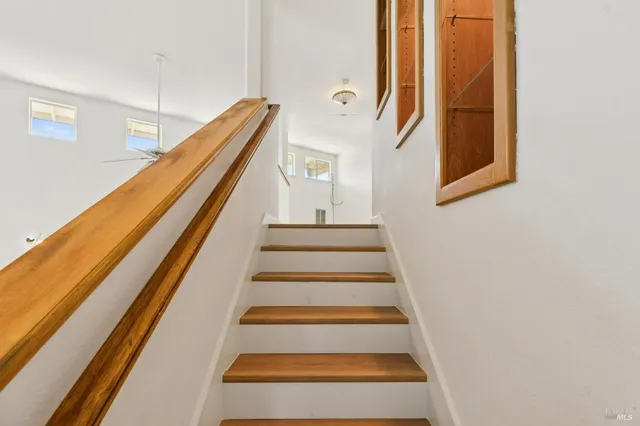 an empty room with windows and cabinet