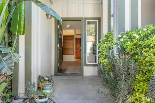 a front view of a house with a garden