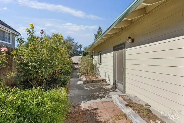 a view of a chair and tables in the patio