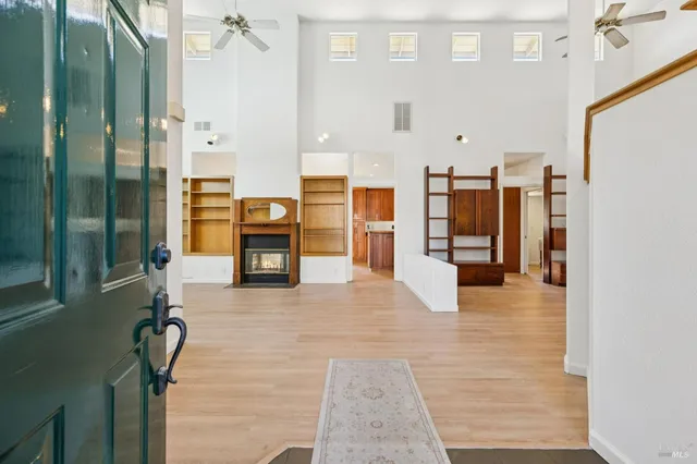 a view of an empty room with glass door and balcony