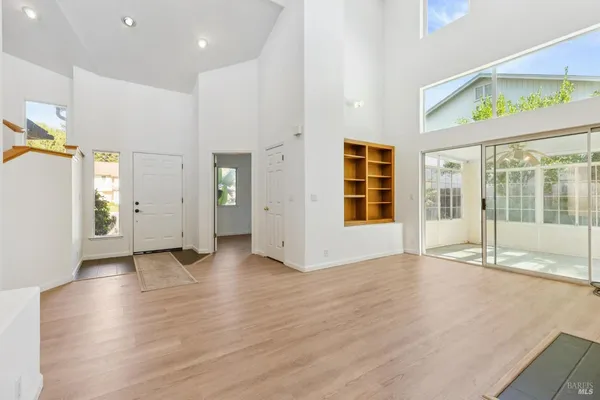 a view of a livingroom with wooden floor and a fireplace