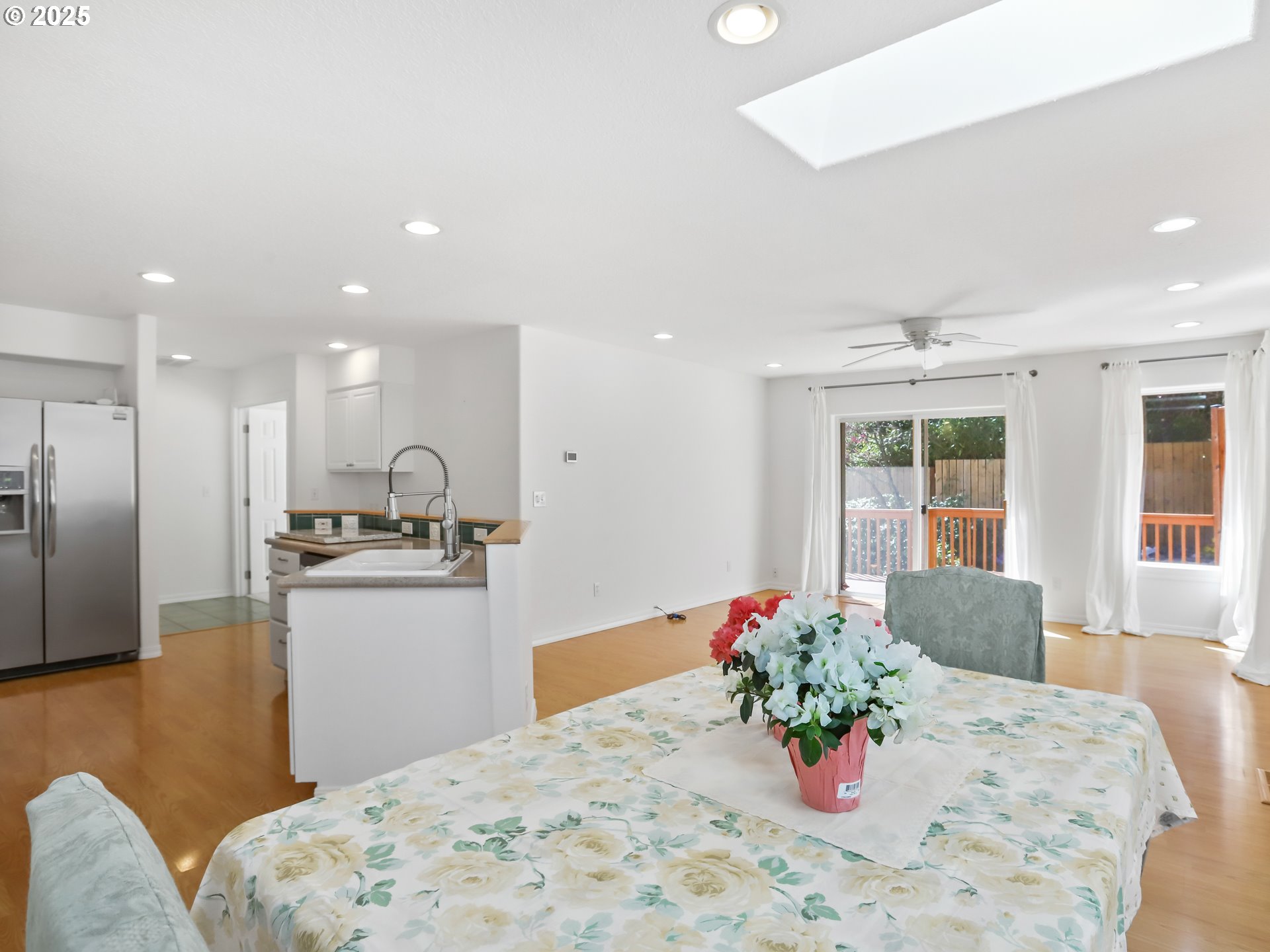 17265 Amber Lane Sandy, OR 97055 - Photo 11 of 46 a kitchen with stainless steel appliances kitchen island granite countertop a refrigerator a sink dishwasher with a dining table and chairs