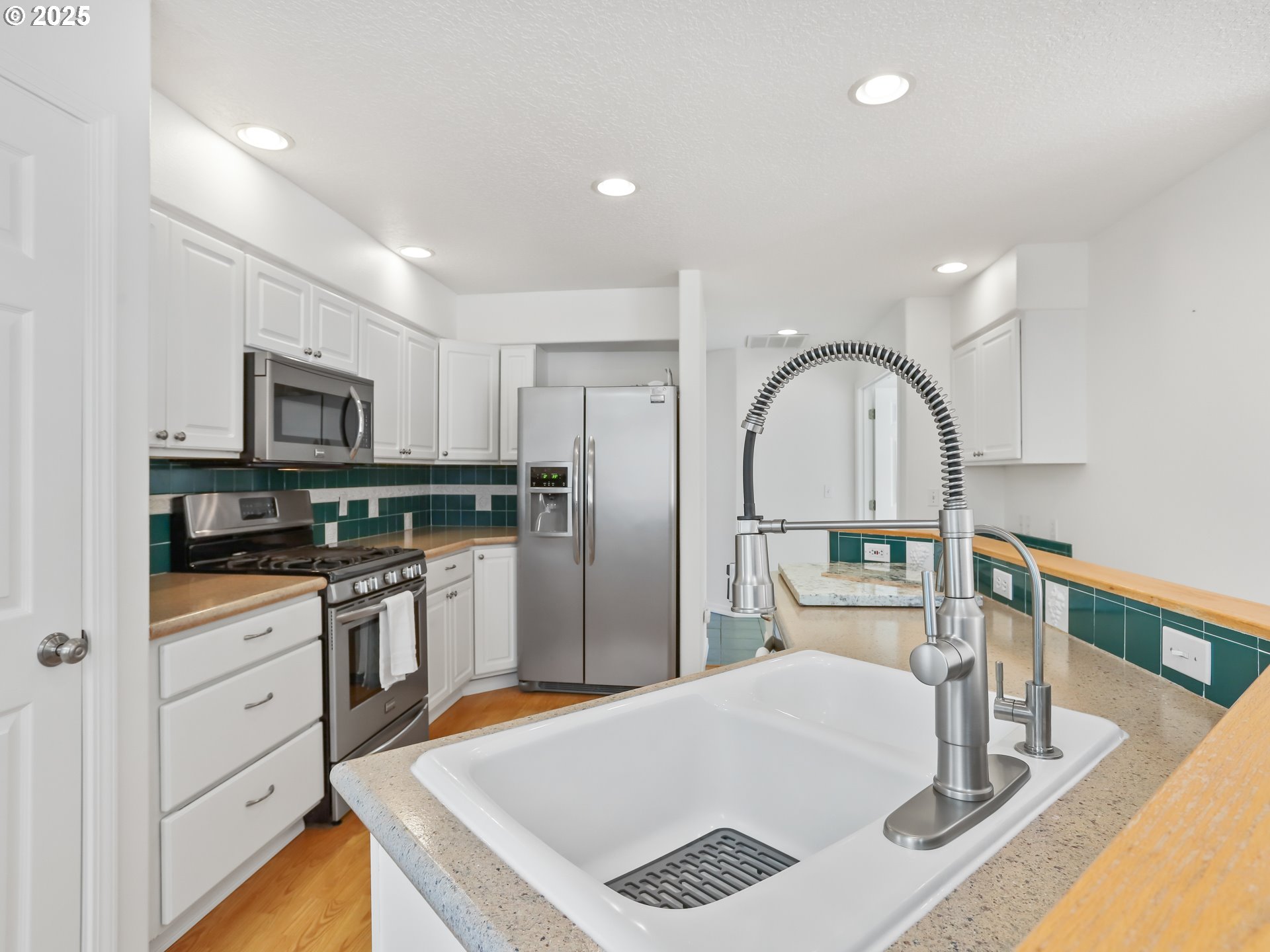 17265 Amber Lane Sandy, OR 97055 - Photo 13 of 46 a kitchen with stainless steel appliances a refrigerator sink and stove