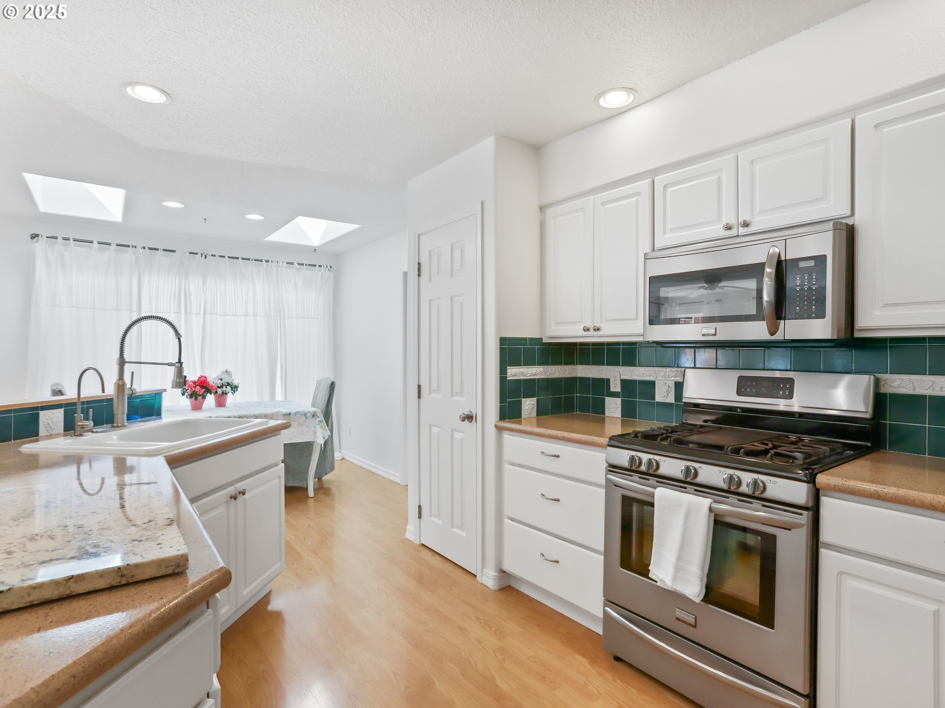 17265 Amber Lane Sandy, OR 97055 - Photo 16 of 46 a kitchen with stainless steel appliances a stove sink and cabinets