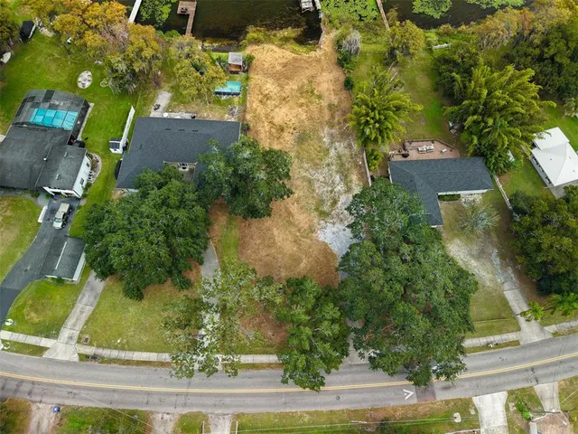 an aerial view of a residential houses with yard