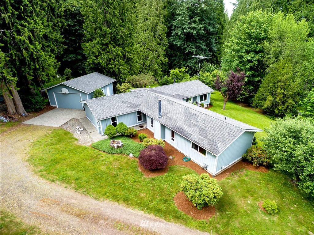 an aerial view of a house with big yard