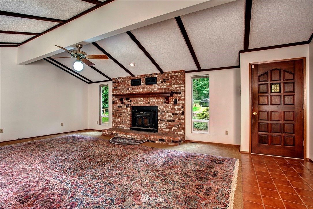 11003 Fay Road Northeast Carnation, WA 98014 - Photo 5 of 25 a view of an empty room with a fireplace and windows
