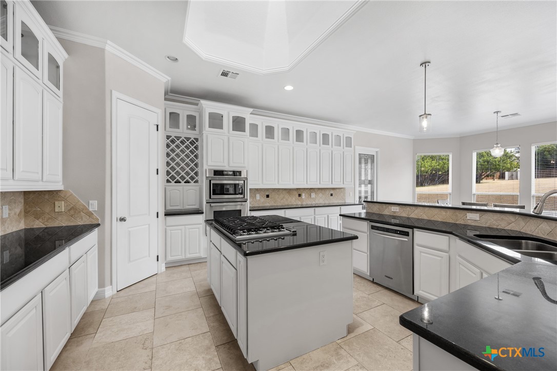 6717 Springwood Court Temple, TX 76502 - Photo 12 of 33 a kitchen with stainless steel appliances granite countertop a stove and a sink