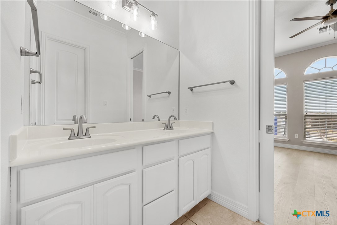 6717 Springwood Court Temple, TX 76502 - Photo 18 of 33 a bathroom with a double vanity sink and a mirror