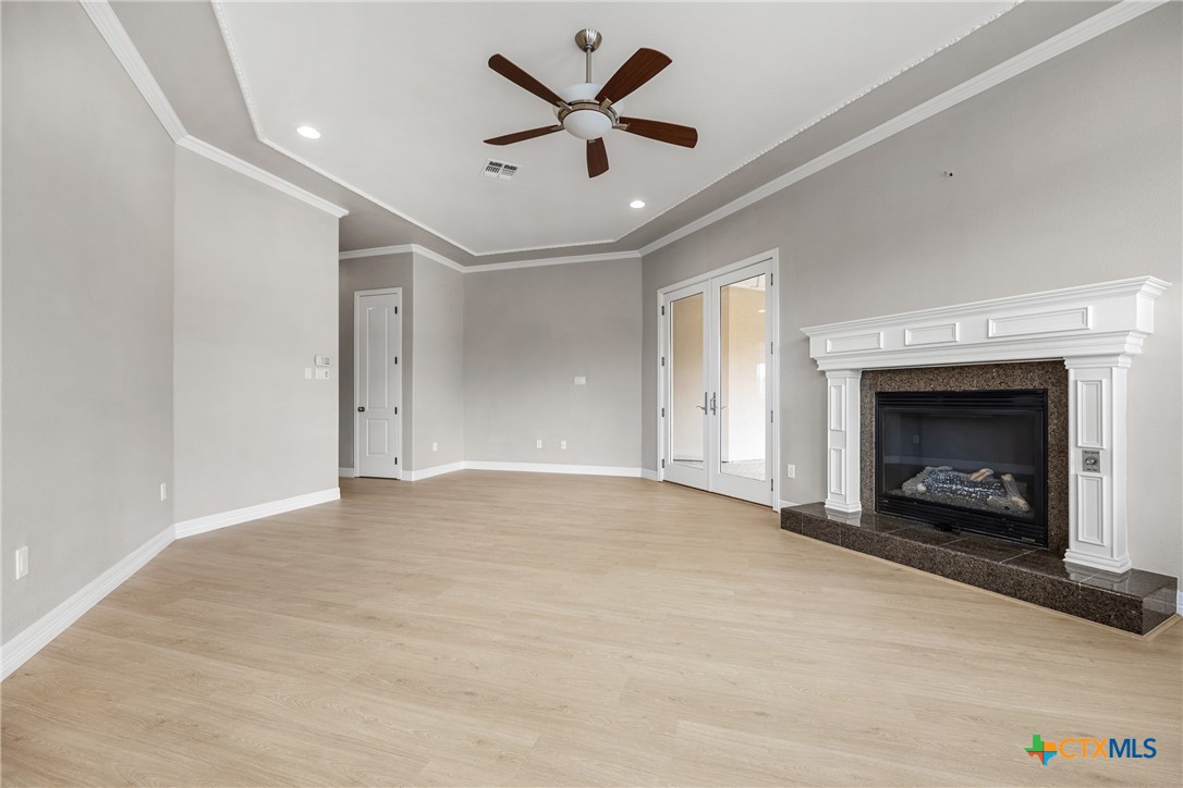 6717 Springwood Court Temple, TX 76502 - Photo 28 of 33 an empty room with fireplace and fan
