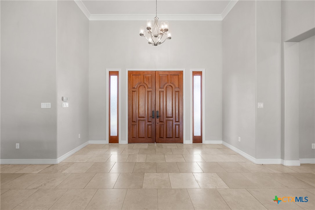6717 Springwood Court Temple, TX 76502 - Photo 5 of 33 an empty room with windows and a chandelier fan