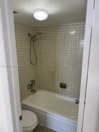 a bathroom with a toilet bathtub and shower