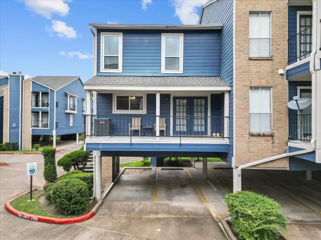 a view of a house with swimming pool and sitting area