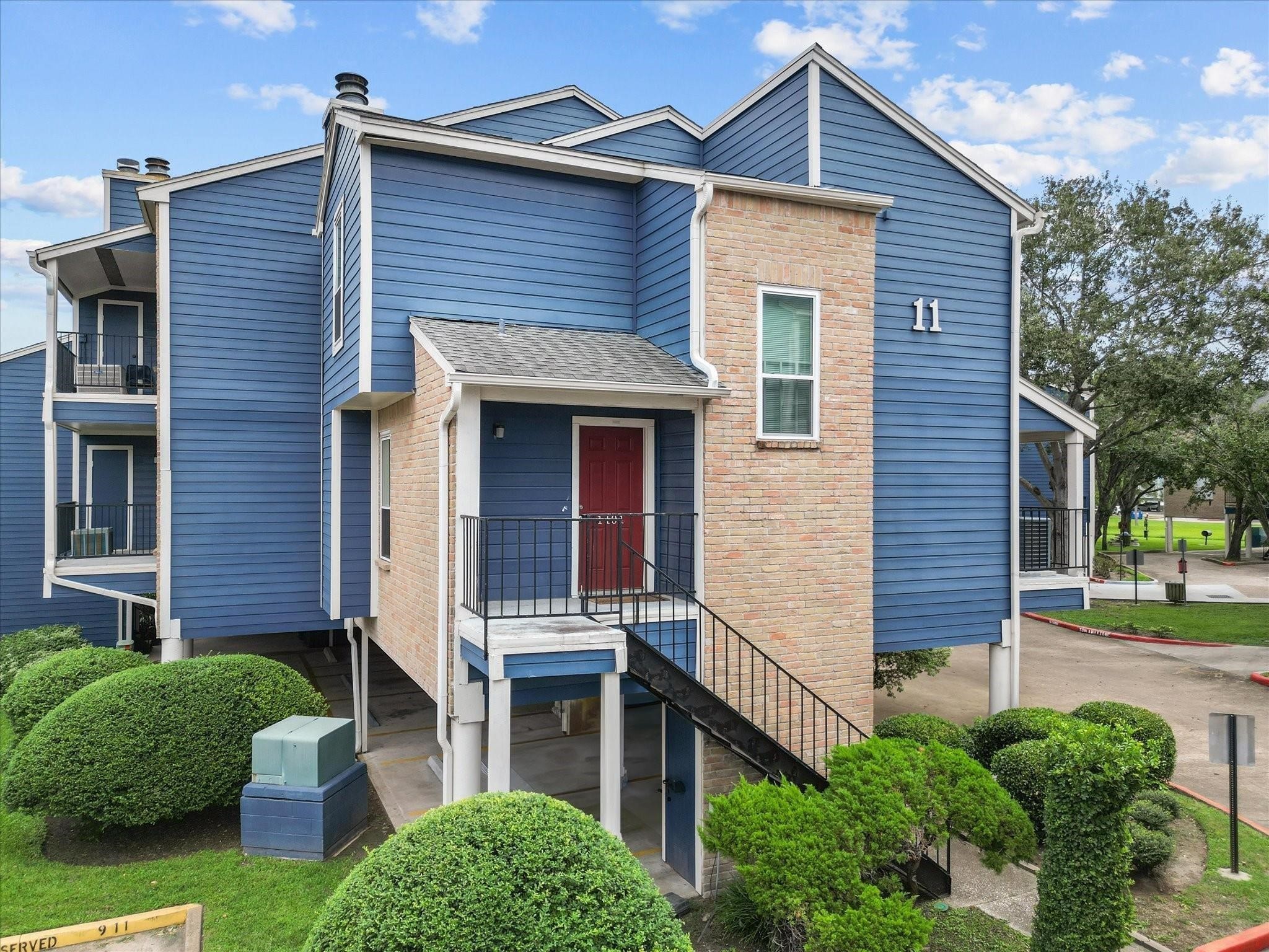 18515 Egret Bay Boulevard, Unit 1101 Webster, TX 77058 - Photo 25 of 30 a front view of a house with a garden