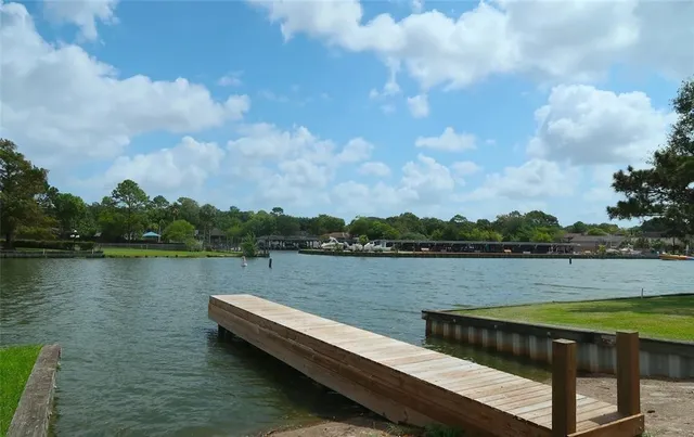 a view of a lake with houses in the background