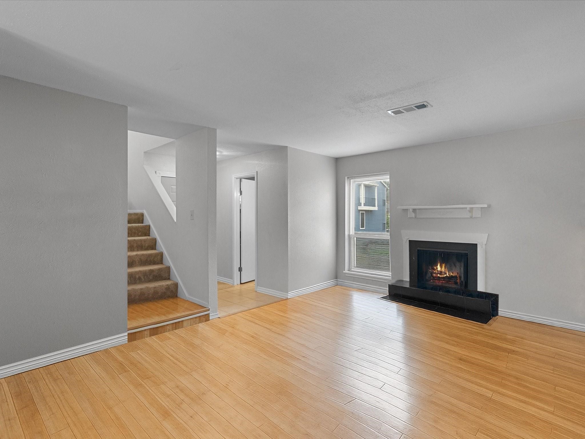 18515 Egret Bay Boulevard, Unit 1101 Webster, TX 77058 - Photo 3 of 30 a view of a livingroom with wooden floor and a fireplace