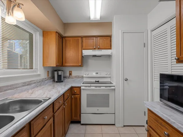 a kitchen with a sink stove top oven and cabinets