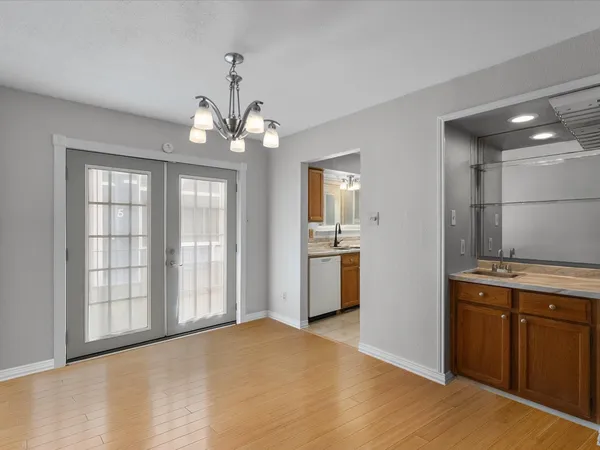 a view of a kitchen with a sink cabinets and wooden floor