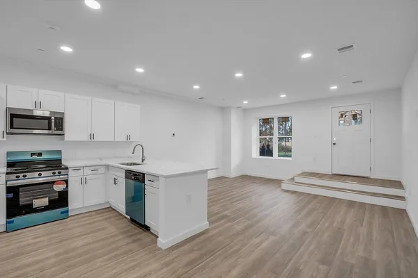 a kitchen with stainless steel appliances granite countertop a stove and a sink
