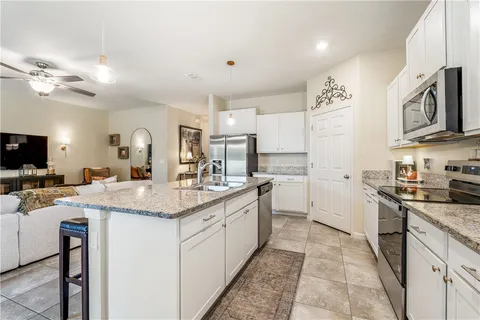 a kitchen with stainless steel appliances granite countertop a sink and cabinets