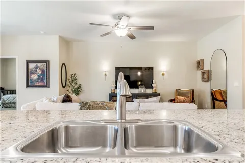 a kitchen with a sink a counter top space and stainless steel appliances