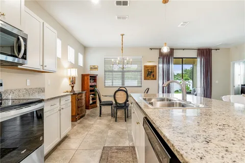 a kitchen with granite countertop sink cabinets and stainless steel appliances