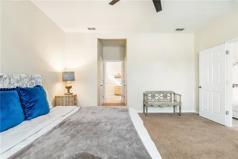 a bedroom with a large bed and a couch