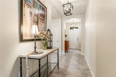 a view of a hallway with dining area and livingroom