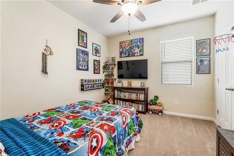 a bedroom with two beds and a chandelier