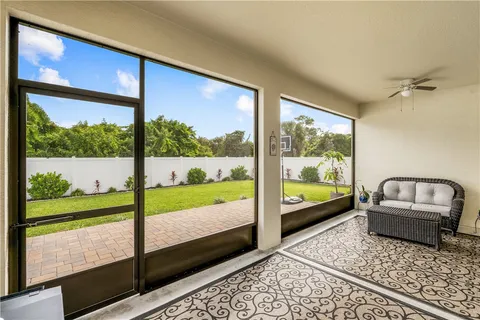 a living room with large window and a table