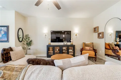 a bedroom with furniture and a flat screen tv