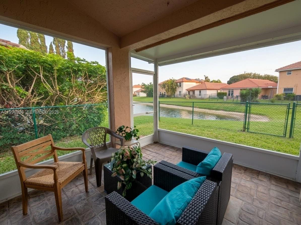 1016 Via Jardin, Unit 1016 Riviera Beach, FL 33418 - Photo 12 of 15 a view of a patio with furniture and a yard