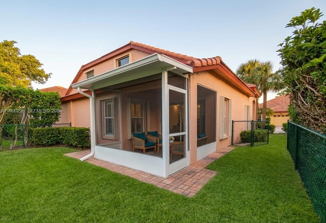 1016 Via Jardin, Unit 1016 Riviera Beach, FL 33418 - Photo 13 of 15 a front view of a house with a yard and porch