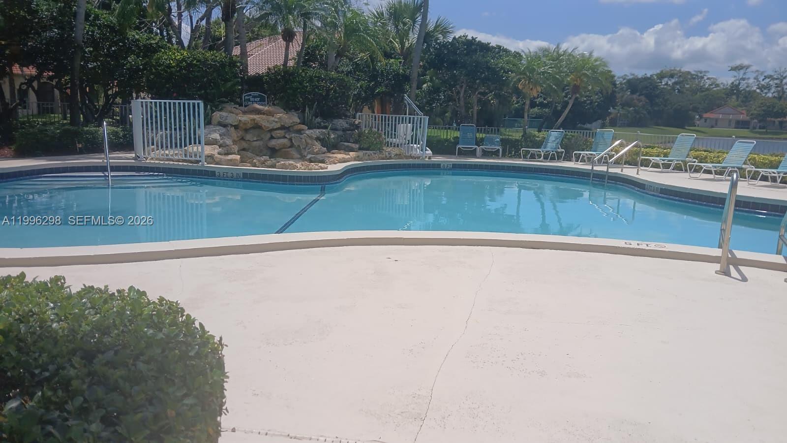 1016 Via Jardin, Unit 1016 Riviera Beach, FL 33418 - Photo 17 of 21 a view of a swimming pool with a yard