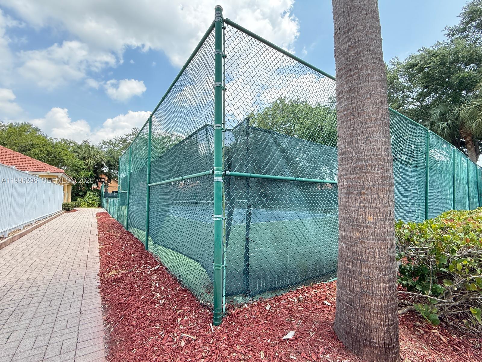 1016 Via Jardin, Unit 1016 Riviera Beach, FL 33418 - Photo 19 of 21 a green field with trees in the background