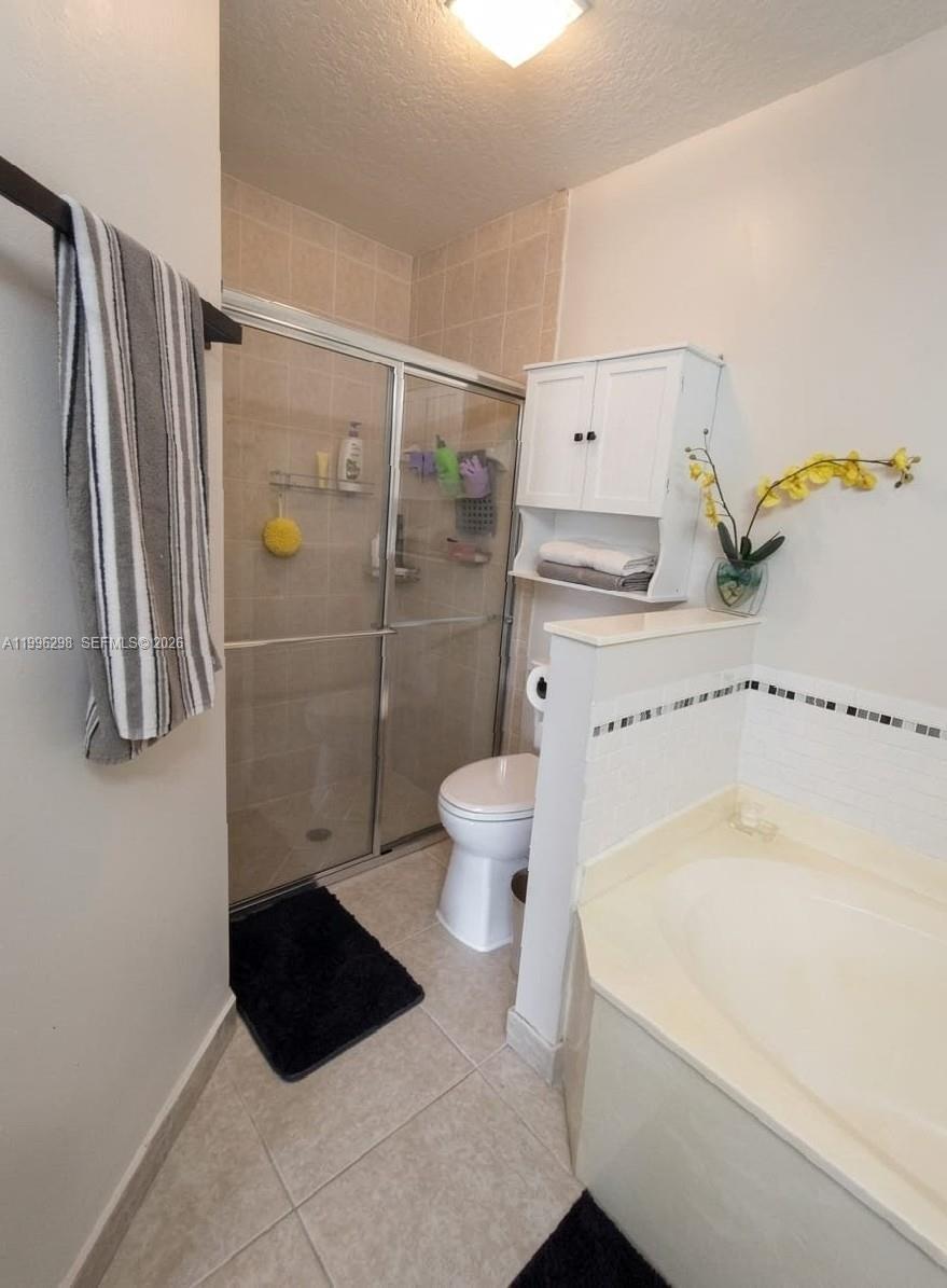 1016 Via Jardin, Unit 1016 Riviera Beach, FL 33418 - Photo 5 of 15 a bathroom with a sink toilet and shower