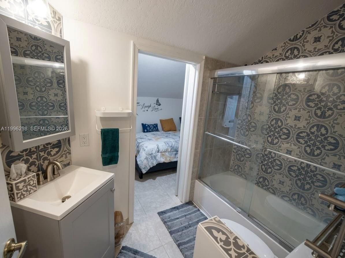 1016 Via Jardin, Unit 1016 Riviera Beach, FL 33418 - Photo 10 of 15 a en suite bathroom with a tub and shower