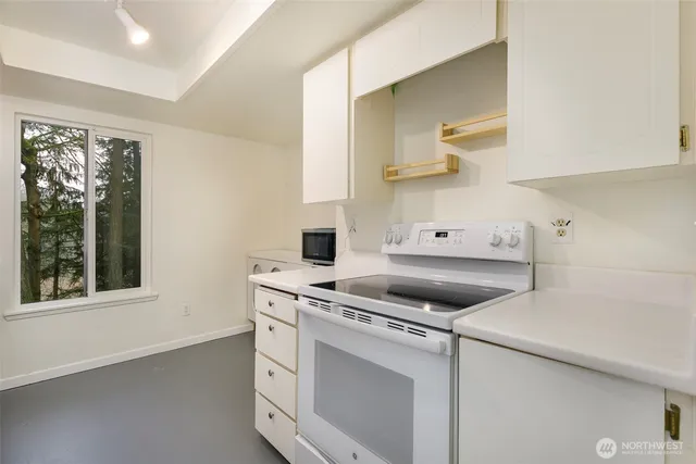 a kitchen that has a stove and a table