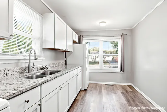 a kitchen with sink cabinets and window