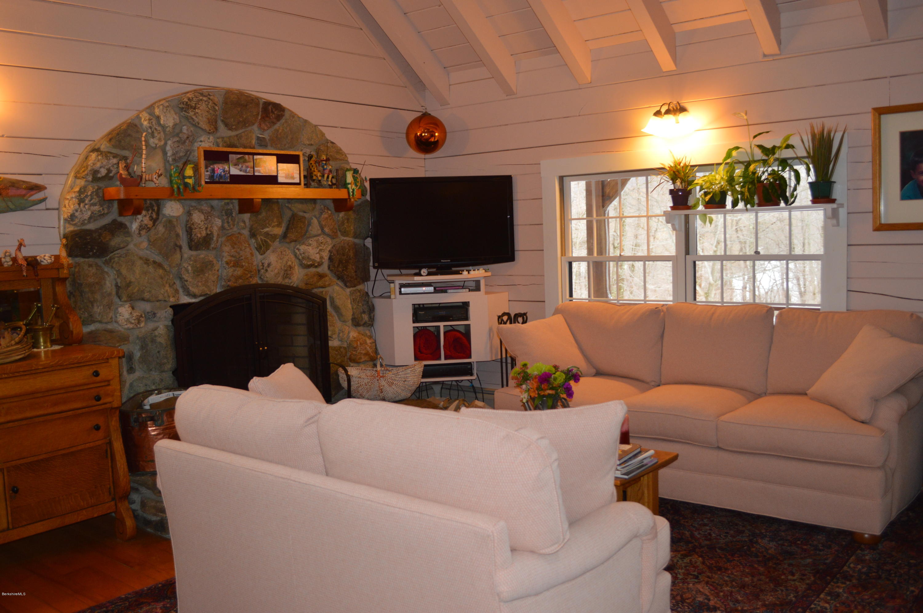 47 Jericho Road Hancock, MA 01267 - Photo 3 of 33 a living room with furniture a flat screen tv and a fireplace