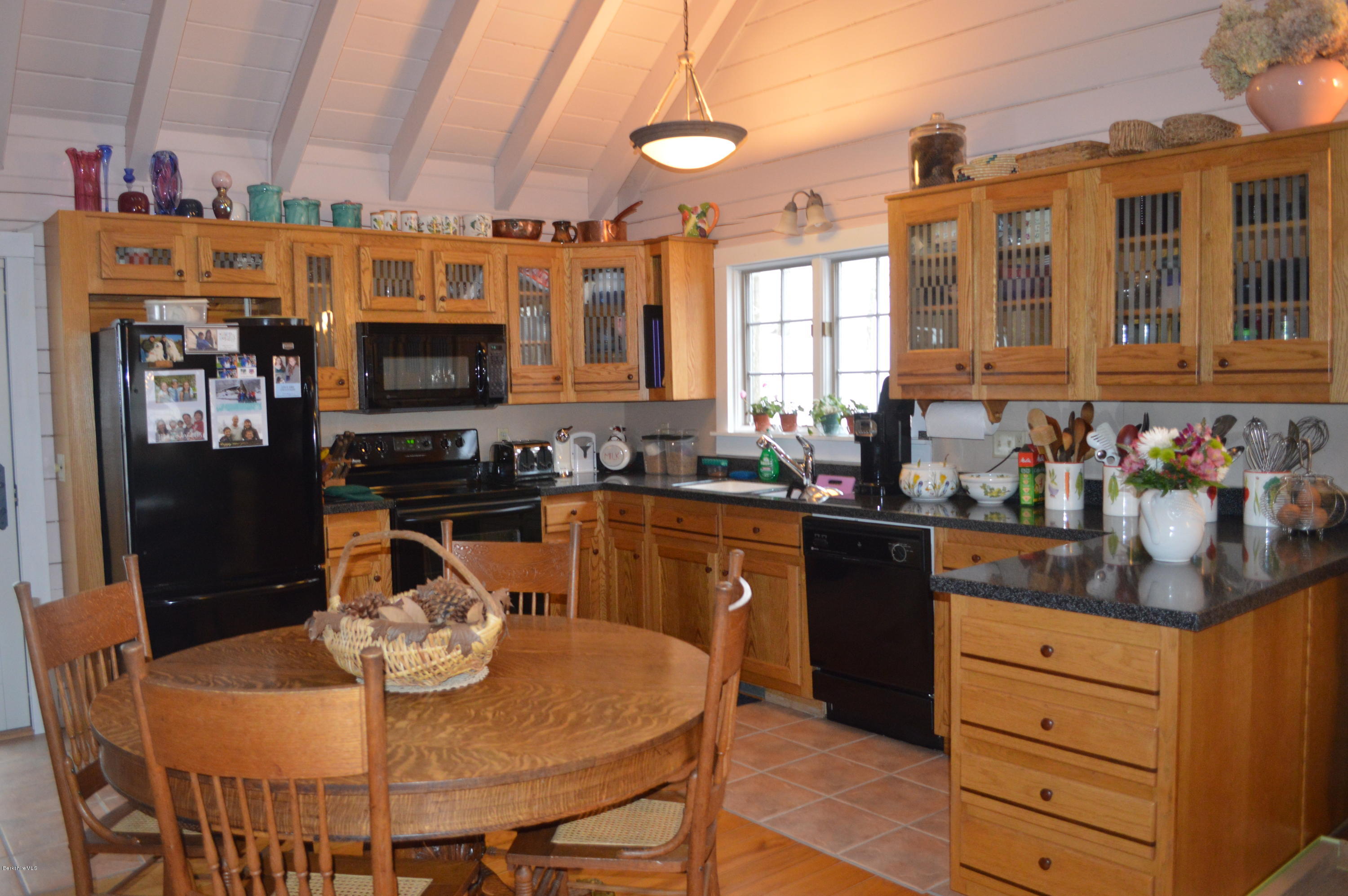 47 Jericho Road Hancock, MA 01267 - Photo 5 of 33 a kitchen with stainless steel appliances granite countertop a stove a sink a refrigerator dining table and chairs
