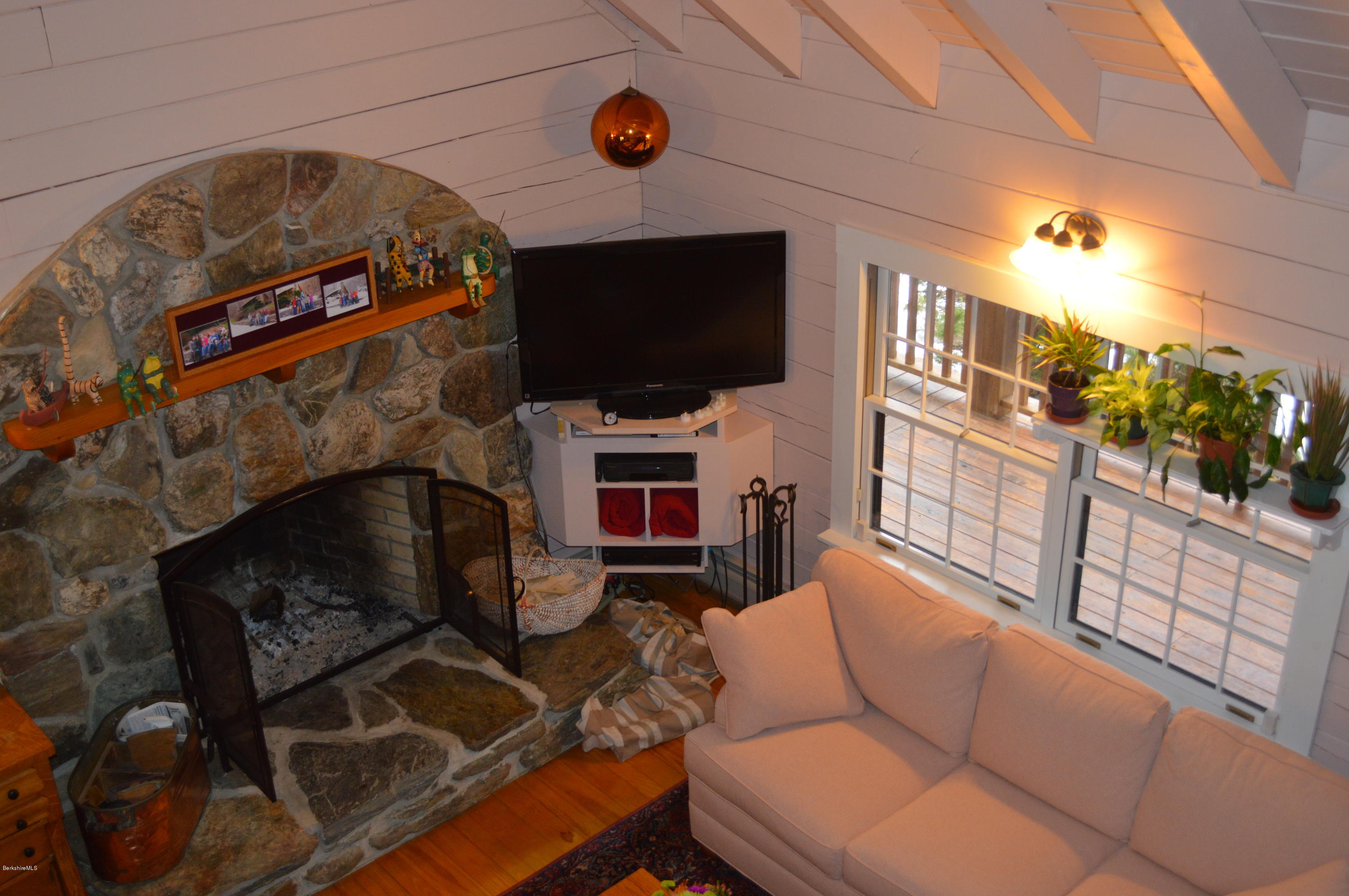 47 Jericho Road Hancock, MA 01267 - Photo 8 of 33 a living room with furniture a flat screen tv and a fireplace