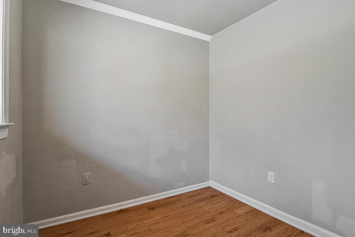 3103 Naylor Road Southeast, Unit 304 Washington, DC 20020 - Photo 18 of 28 a view of an empty room with wooden floor