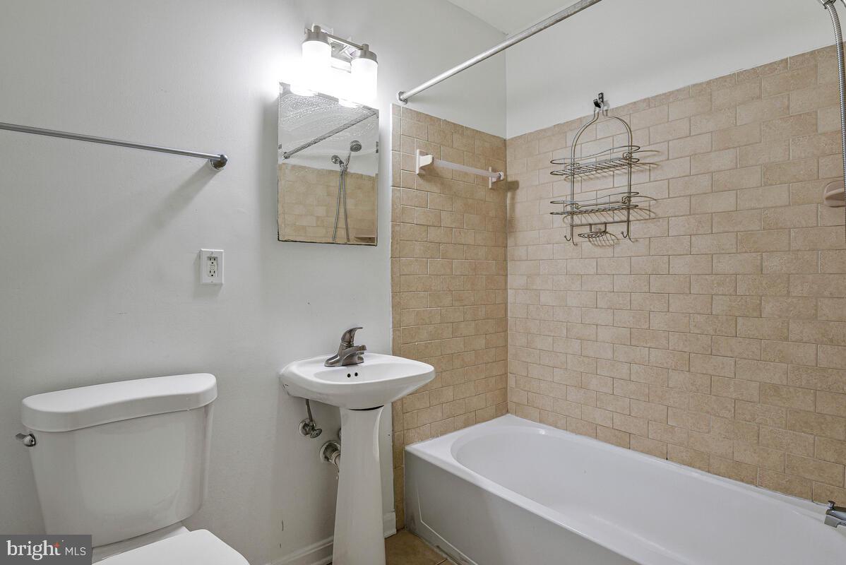 3103 Naylor Road Southeast, Unit 304 Washington, DC 20020 - Photo 21 of 28 a bathroom with a sink a toilet and shower